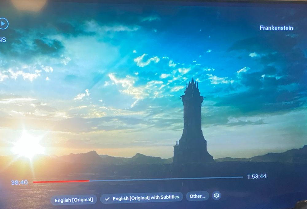 Screenshot from Frankenstein showing the tower where Victor sets up his laboratory against a setting Sun.