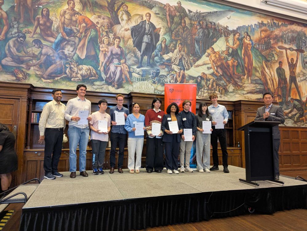 A group of the students receiving an award at the ceremony, on stage: presented by Dr Mohammad Polash and Prof. Jinman Kim.