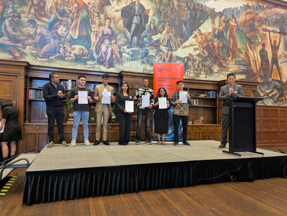 A group of the students receiving an award at the ceremony, on stage: presented by Dr. Suranga Seneviratne and Prof. Jinman Kim.