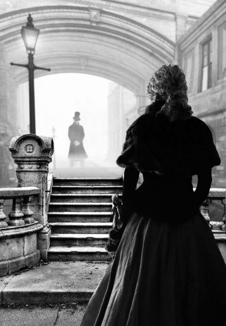 A black and white picture of a woman in a dress facing a man through fog on the streets of London