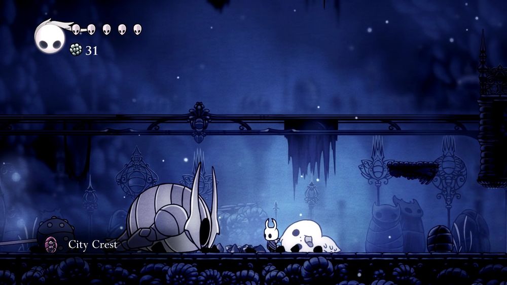 The bug from Hollow Knight standing before the corpse of the False Knight.