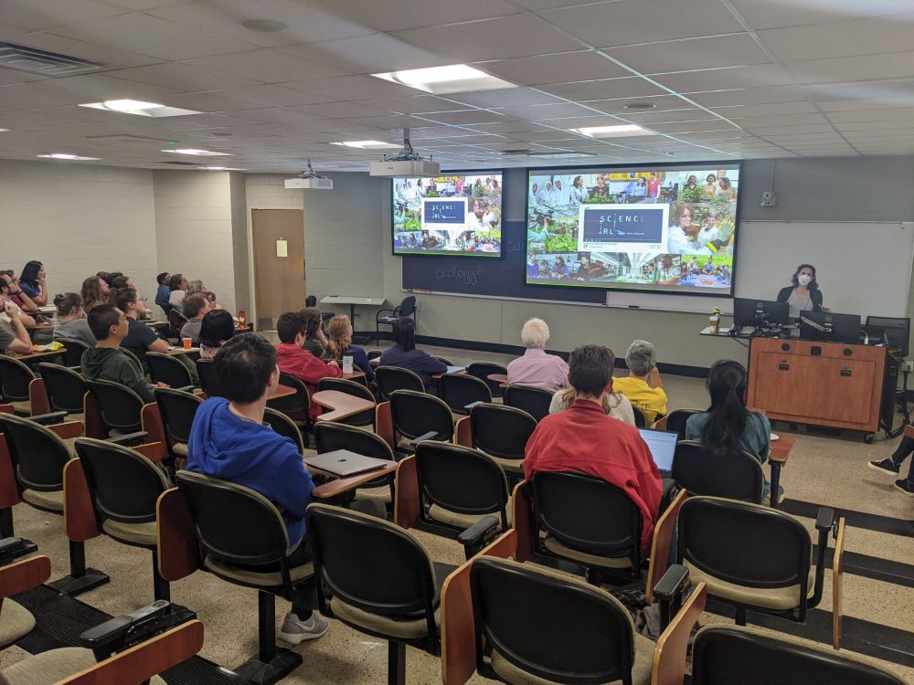 Molly in a respirator giving a talk about scicomm and Science IRL for the plant bio departmental seminar at UGA. Photo Credit: Tanisha Williams 