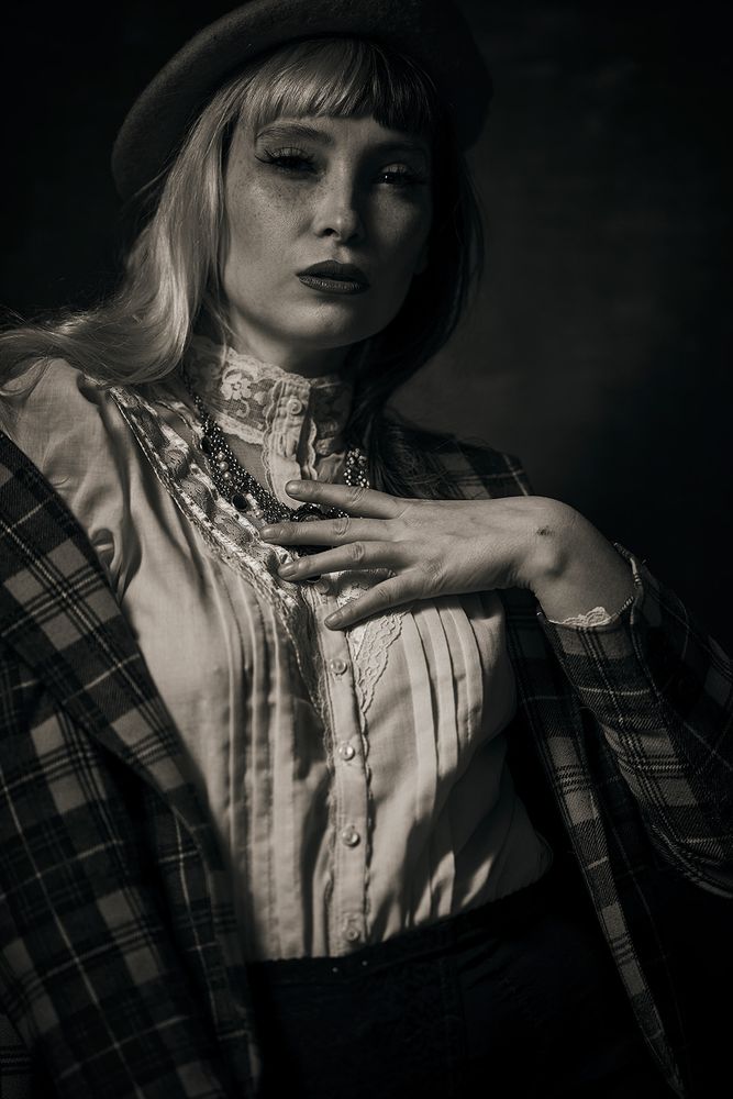 Black and white portrait of model Haley Valentine, wearing a smart outfit complete with beret.