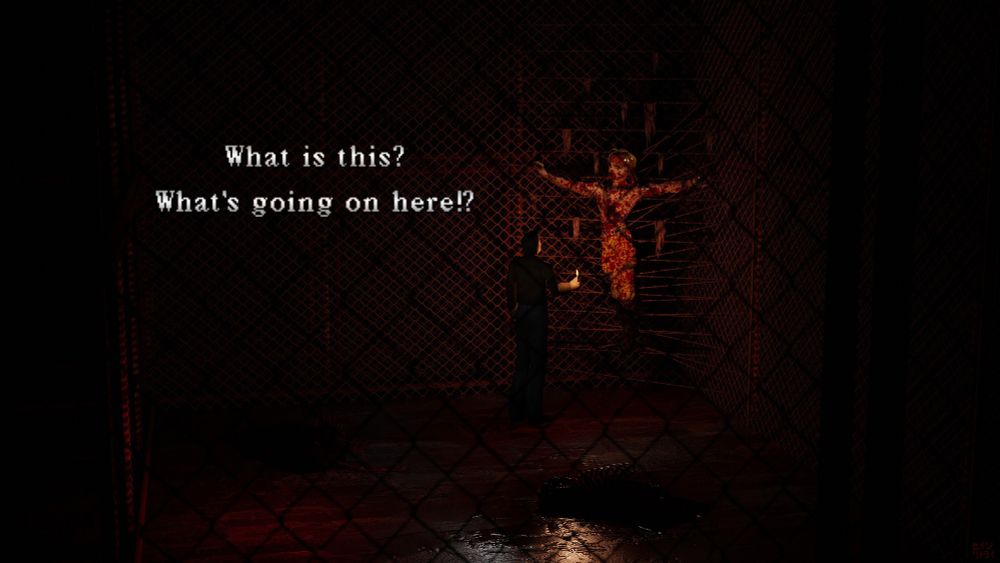 Through a chain link fence, we see Harry Mason in the Silent Hill 1 prologue. He is surrounded on all sides by rusty metal fences and barbed wire in a narrow alley. The ground is wet with rain and blood. The scene is very dark, illuminated only by the flame of Harry's lighter, which he holds in his right hand. He is examining a figure who appears to be crucified and strung up on countless strands of barb wire. Strips of what might be fabric or possible skin dangle from the barbed wire. The figure is covered in blood. It is the concept art version of Steve Burnside, from Resident Evil Code: Veronica. There is text to the left of Harry in the original Silent Hill 1 font. Harry is saying, "What is this? What's going on here!?"