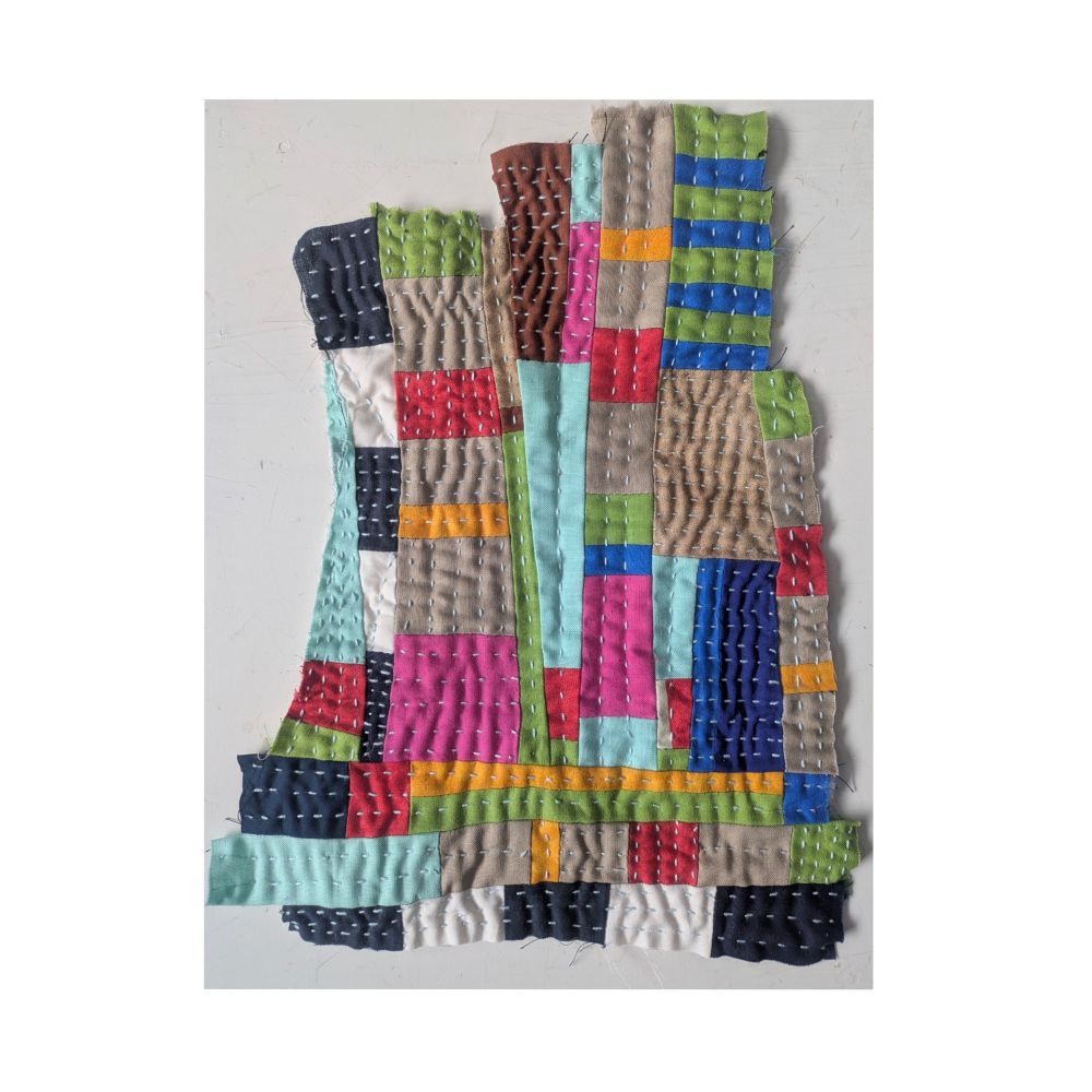 Colorful and embroidered small scrap quilt