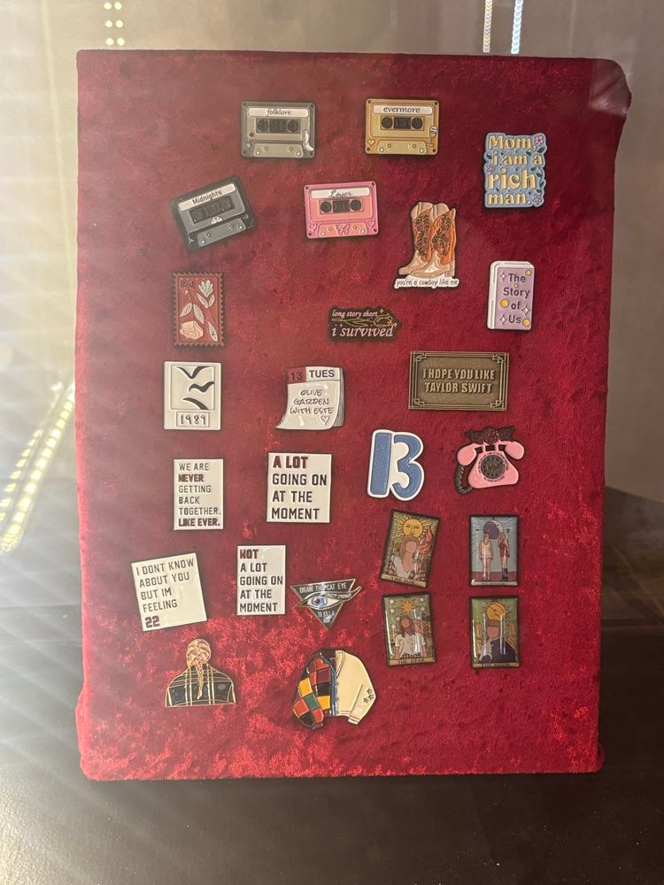 An assortment of Taylor Swift themed pins (and one Cher one)