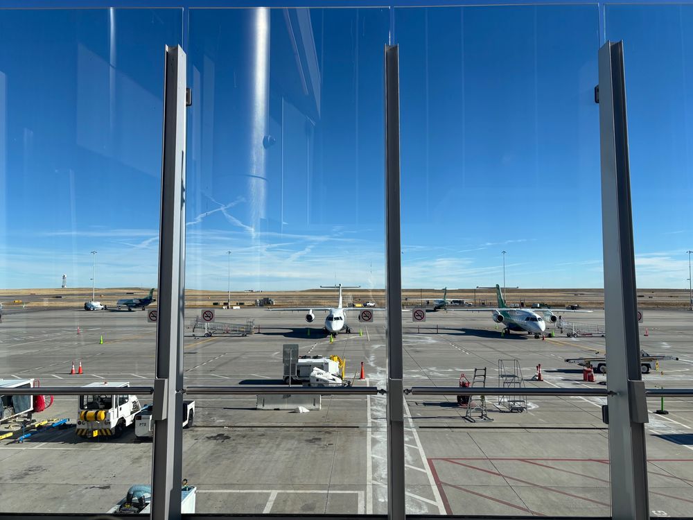 Dornier 328 jets parked on an airport ramp.