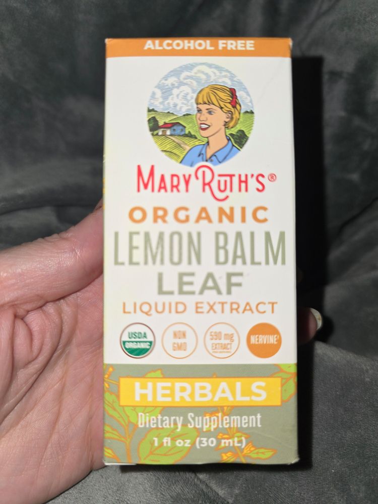 Hand holding a box of Mary Ruth's brand organic Lemon Balm Leaf Extract. Poster plans to test it against heart rate data on a Garmin watch to see if it helps POTS symptoms.