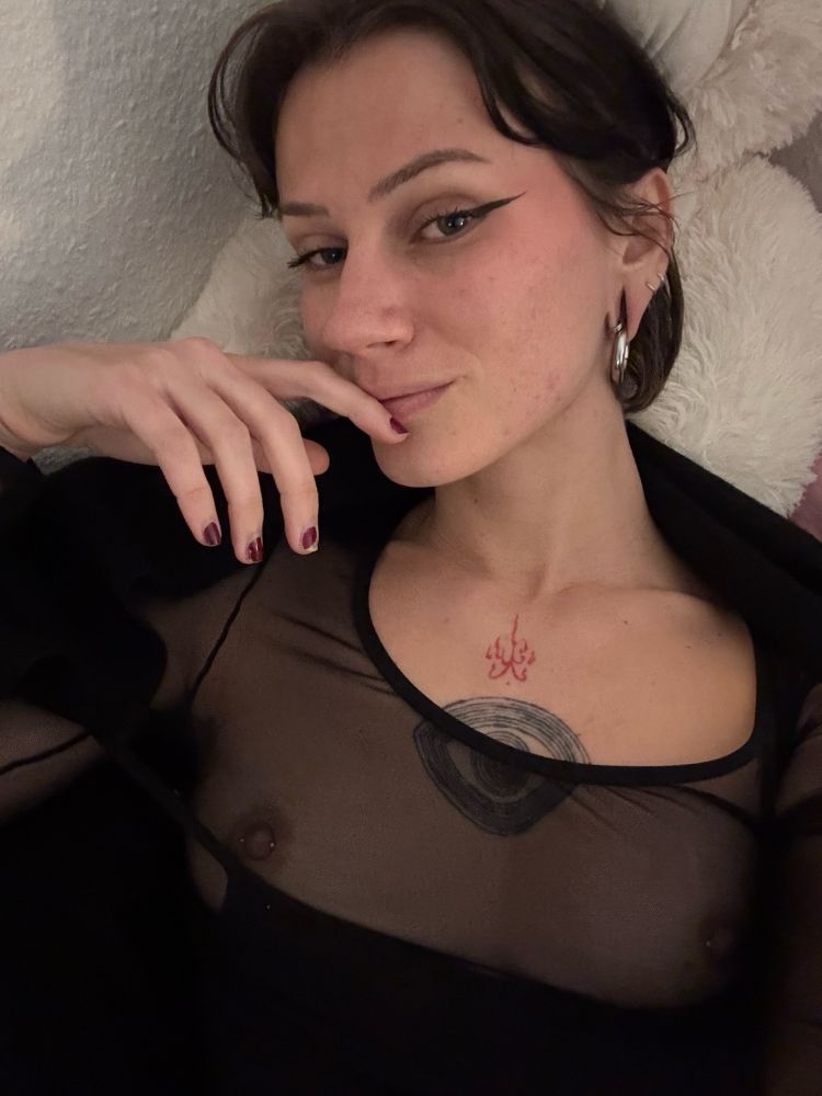 selfie of Żądza wearing a mesh top showing her pierced nipples