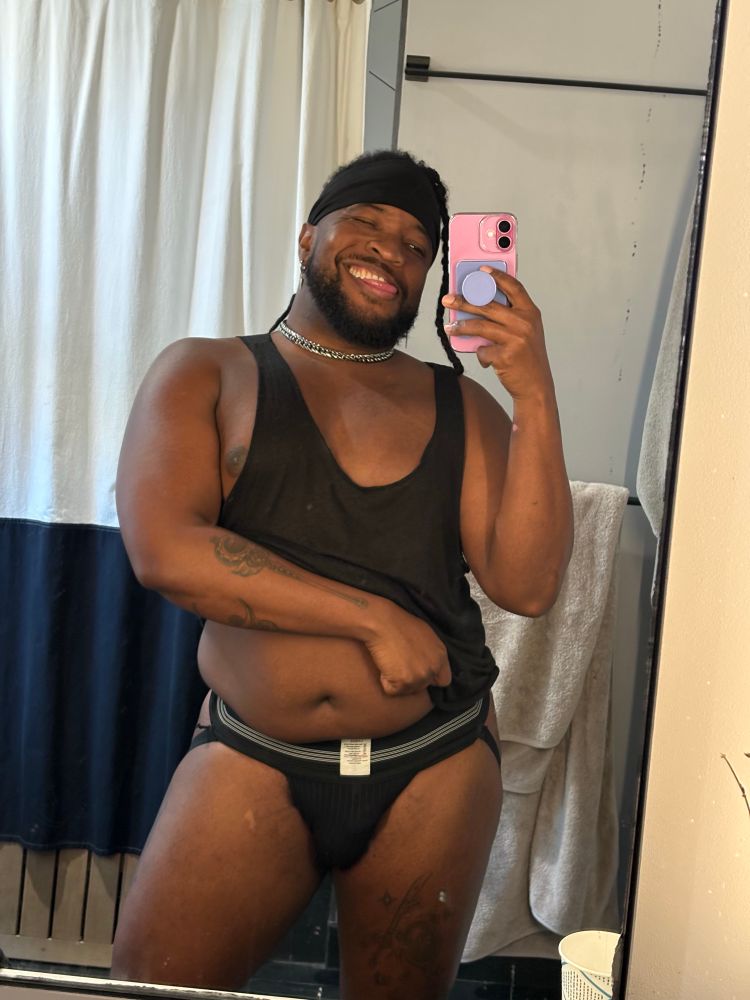 Picture of me in a black jock strap lifting my tank top up.
