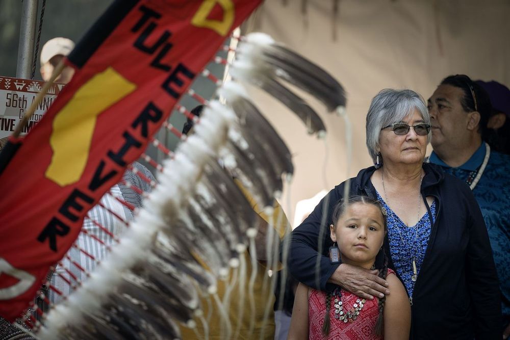 Denise Padgette, of the Tolowa Dee-ni’ Nation, holds granddaughter, Lola Lopez, during a celebration of California Native American Day at the state Capitol on Sept. 22, 2023. Photo by Miguel Gutierrez Jr., CalMatters