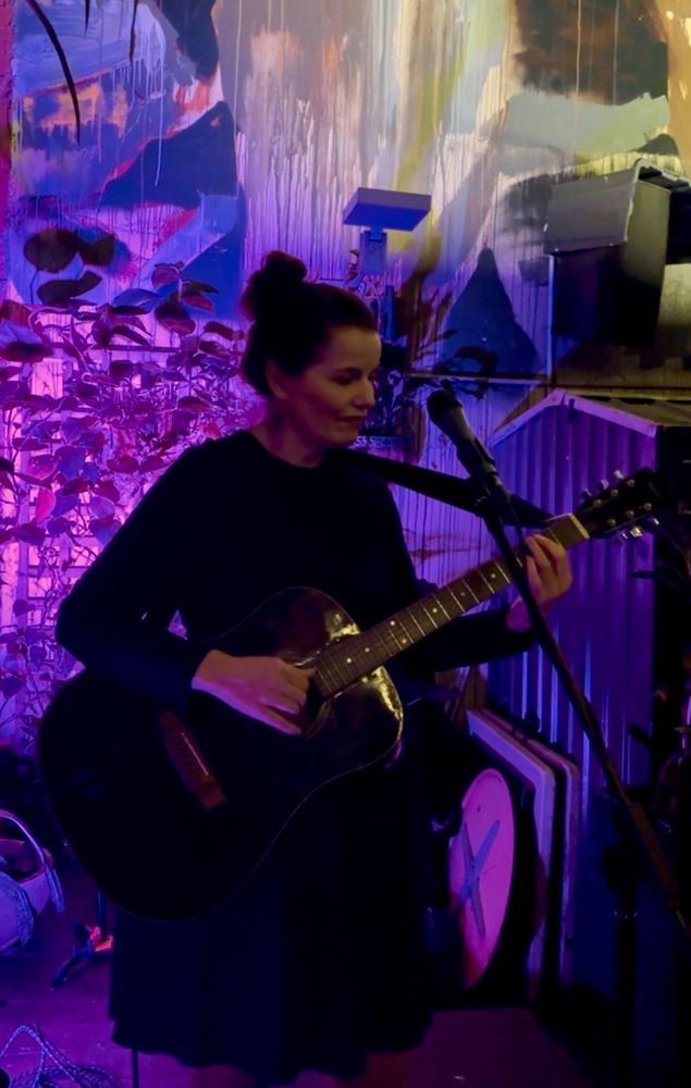 Cassandra Oscar playing guitar