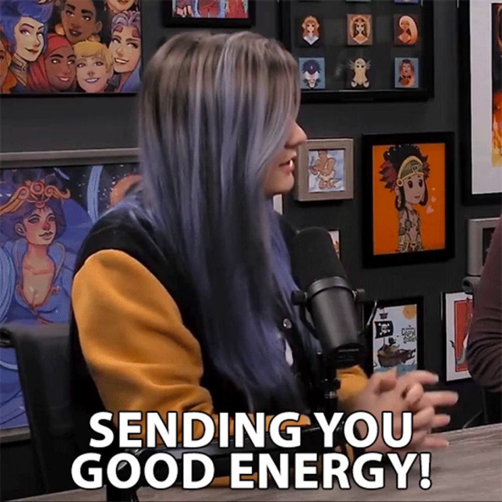 a woman sitting in front of a microphone with the words sending you good energy above her