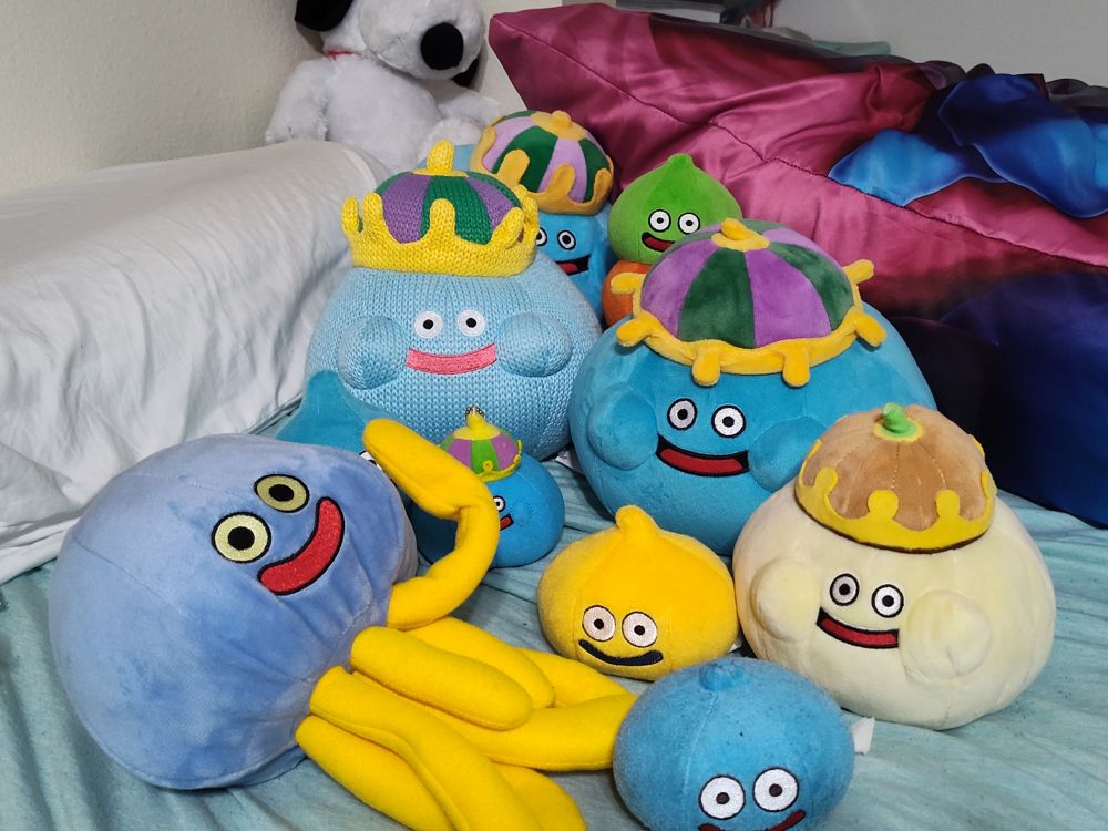 An assortment of slime plushies on a bed

+ Snoopy plush