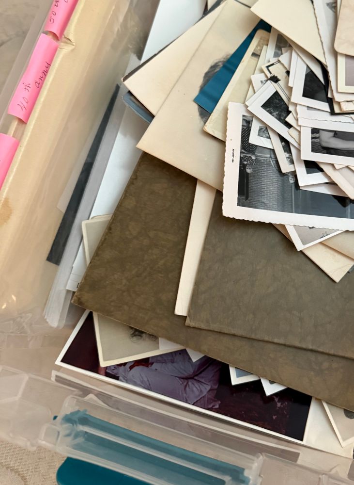 Box full of various old family photographs and documents ready to be scanned and digitized. 