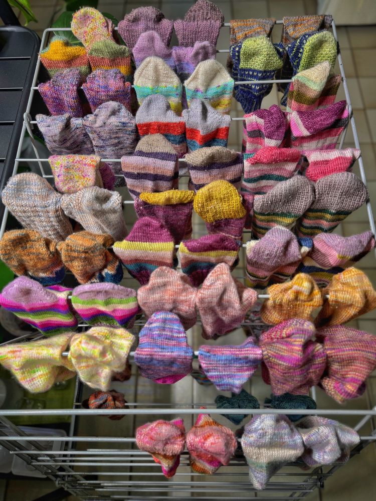 Drying rack full of colorful handknit socks