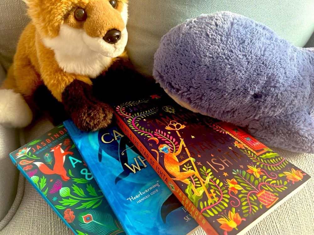 Book pile. Books from Jasbin Bilan. A cuddly whale called Angus and fox called Chand - key characters in two of her books 