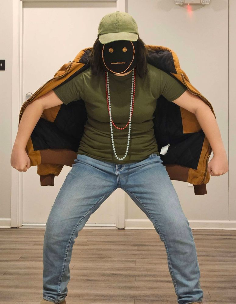 photo of my kay madere cosplay. i am standing in a hallway looking at the viewer in a very threatening stance. 