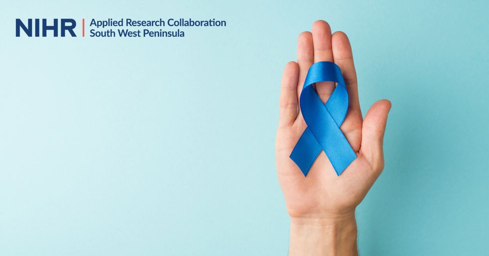 A hand holding a blue ribbon representing prostate cancer.