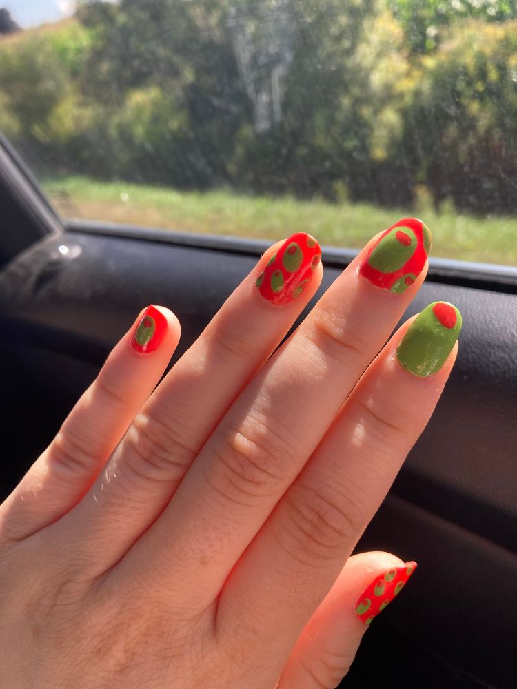 An orange and green olive themed manicure.