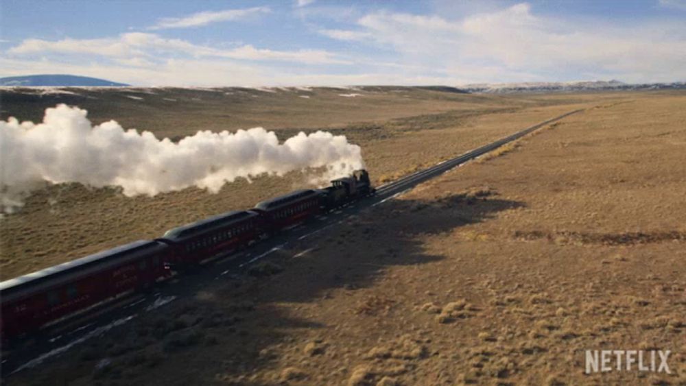 a train going through a desert with netflix written on the bottom