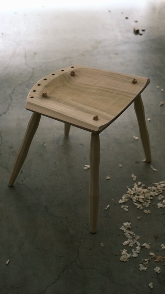 A partially assembled side chair with just the undercarriage assembled