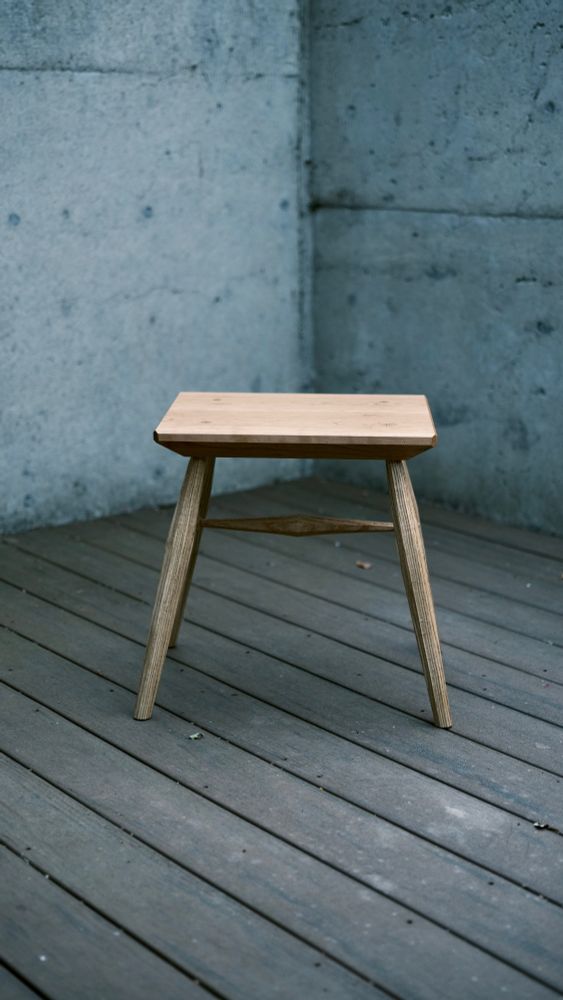 Front view of a stool made with a cherry top and oak legs/undercarriage