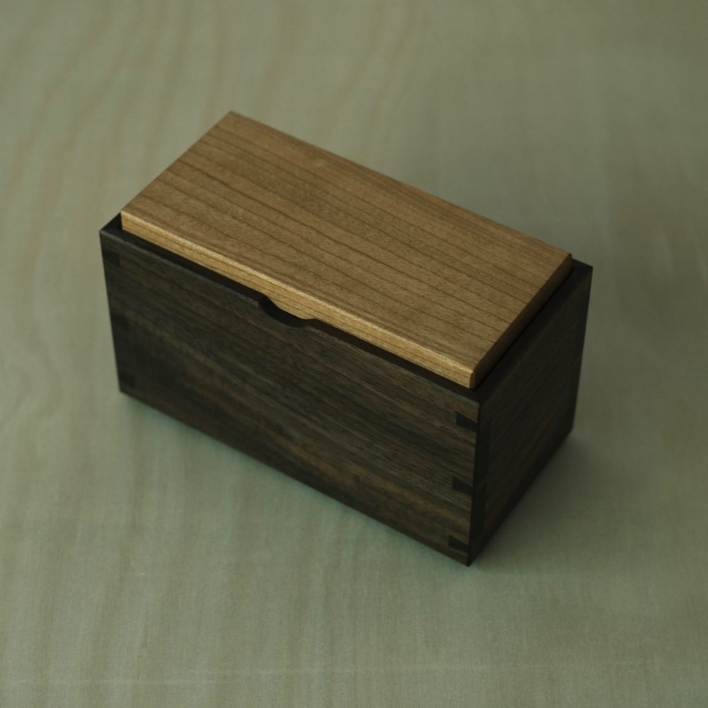 A dovetailed walnut tea box with a cherry lid 