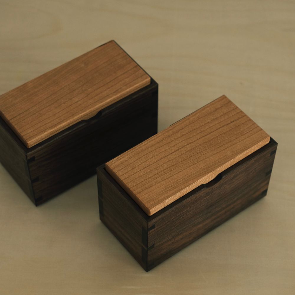 Two walnut and cherry tea boxes viewed from above 
