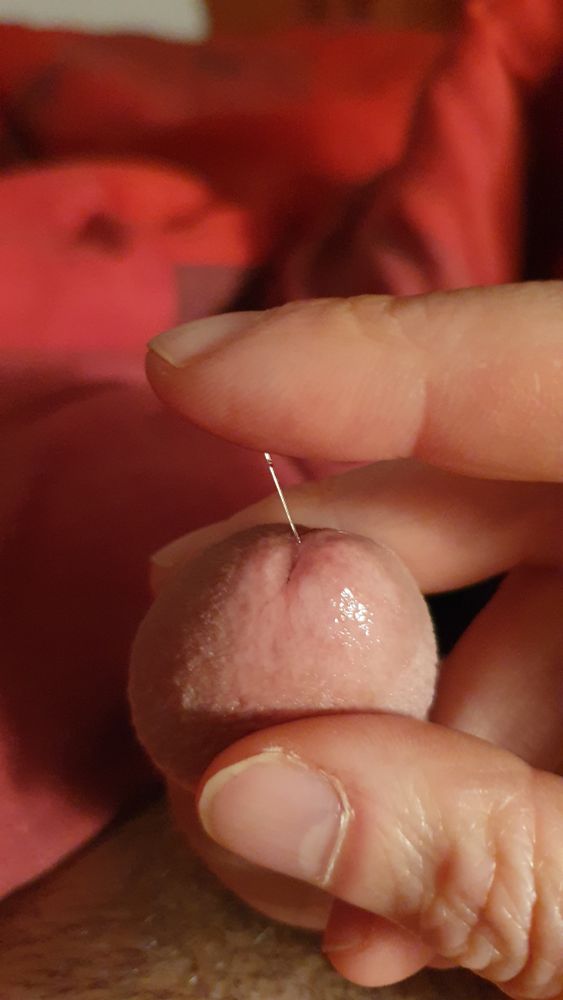 My cock, with a string of precum coming from the tip to my finger
