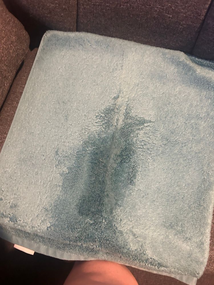 Zel’s office chair with a folded towel on the seat, it is no longer dry but indeed soaked in a stripe down the centre towards the front of the chair.