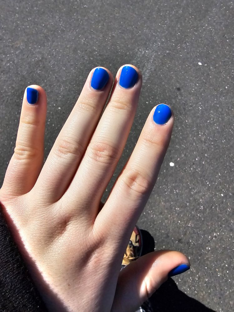 My left hand with blue nails after a manicure