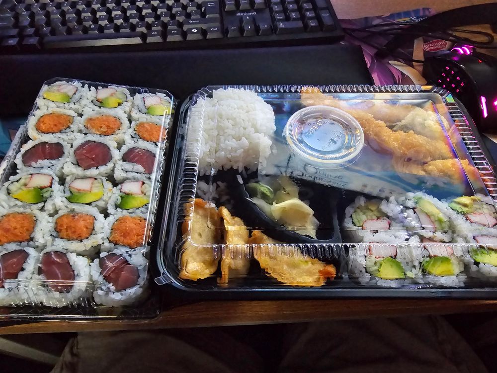 Shrimp tempura bento box and sushi meal.