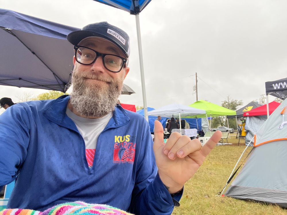 me looking enthusiastic at an elimination race in the rain. tents around me