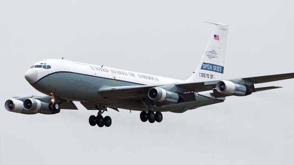 A color photograph of a US Air Force Open Skies Boeing OC-135B observation aircraft coming in for a landing (note the "OPEN SKIES" designation on the tail).