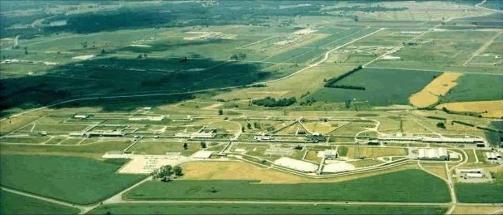 An aerial color photograph of the Atomic Energy Commission's Iowa Army Ordnance Plant in Burlington, Iowa, surrounded by farm fields.