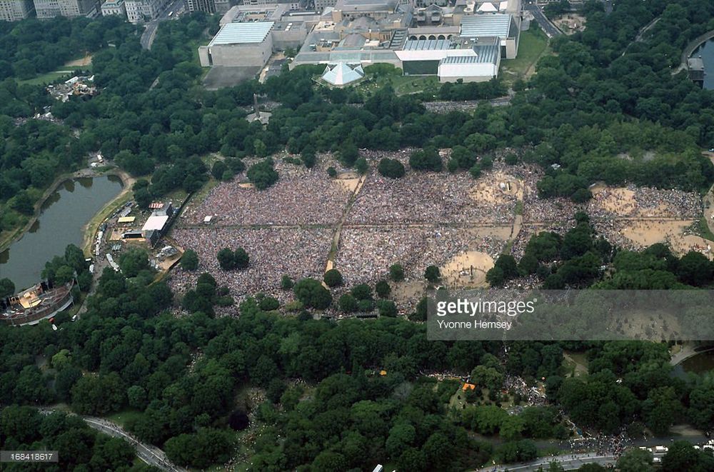 An aerial color photograph showing the Great Lawn in Central Park almost completely filled with people.
