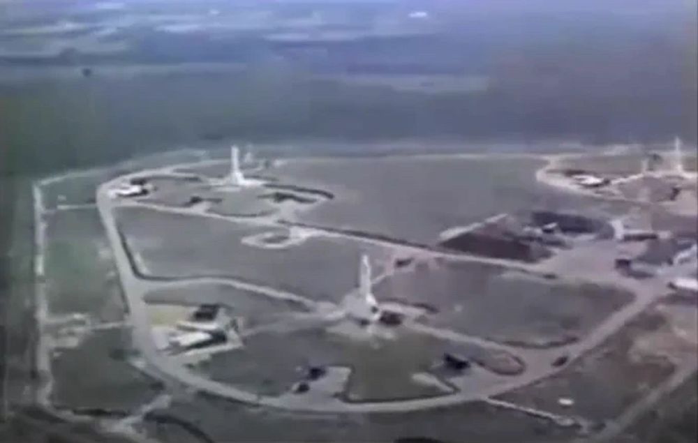 A low-resolution color screenshot from a declassified film (linked in the next post) showing a low-level aerial look at three Jupiter IRBMs deployed at Gioia Del Colle Air Base.