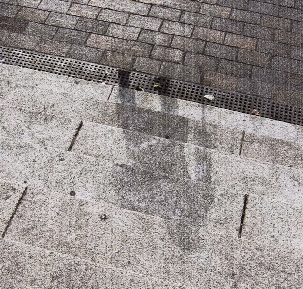 A photograph of a shadow of a person living in Hiroshima on August 6, 1945, who was vaporized as they climbed the steps of the Sumitomo Bank building while using a cane, leaving behind only their shadow imprinted on the steps (because their body and cane momentarily blocked the light from the intense thermal flash, burning away everything on the steps that was not in shadow).