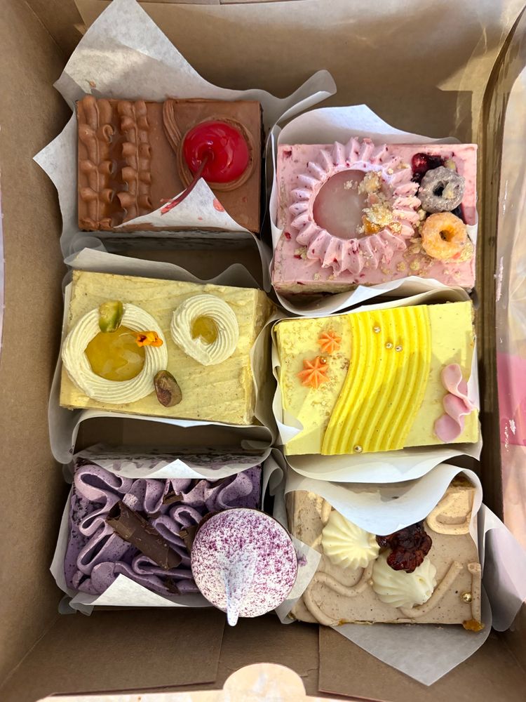 Six slices of colorful and intricately decorated layer sheet cake from Paper Cake Co in Seattle 