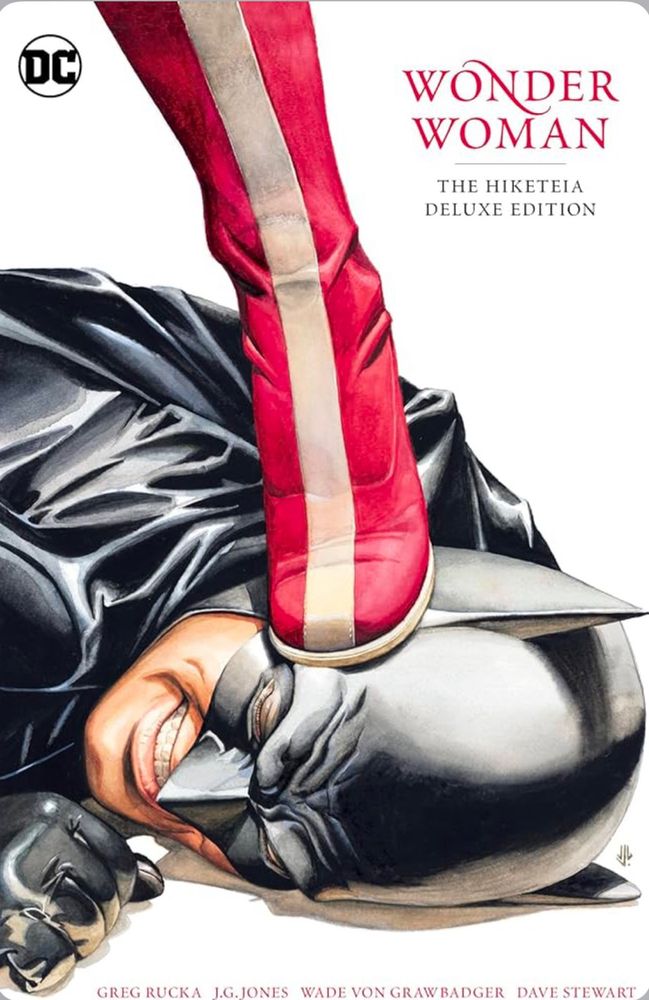 Cover of comic book Hiketeia 

It's Batmans face against the floor while Wonder Woman's boot steps on him