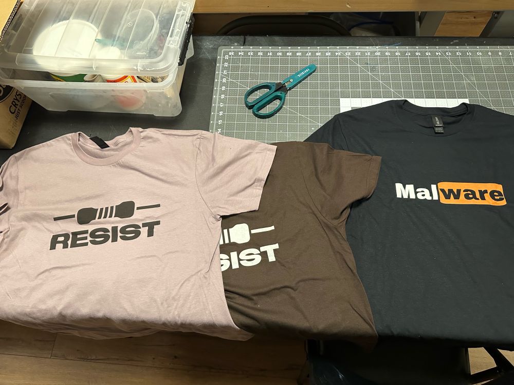 RESIST and MAL WARE shirts