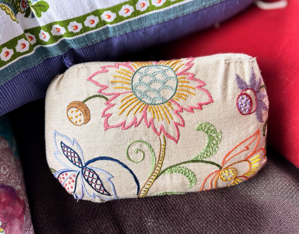 Small rectangular cushion in beige linen with hand embroidered Jacobean style flowers and leaves