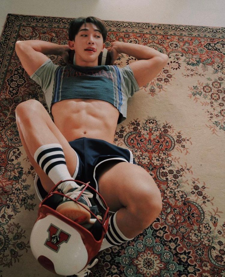 Look I don't even know. Wonho laying on his back on a carpet, head resting on a football, feed on the floor and one foot holding a football helmet. he's wearing a green T-shirt cropped juuuust below his nipples and tiny shorts which are gaping a bit at the hem; while his junk isn't technically visible,the photo sure suggests it would be of the lighting was slightly better. 