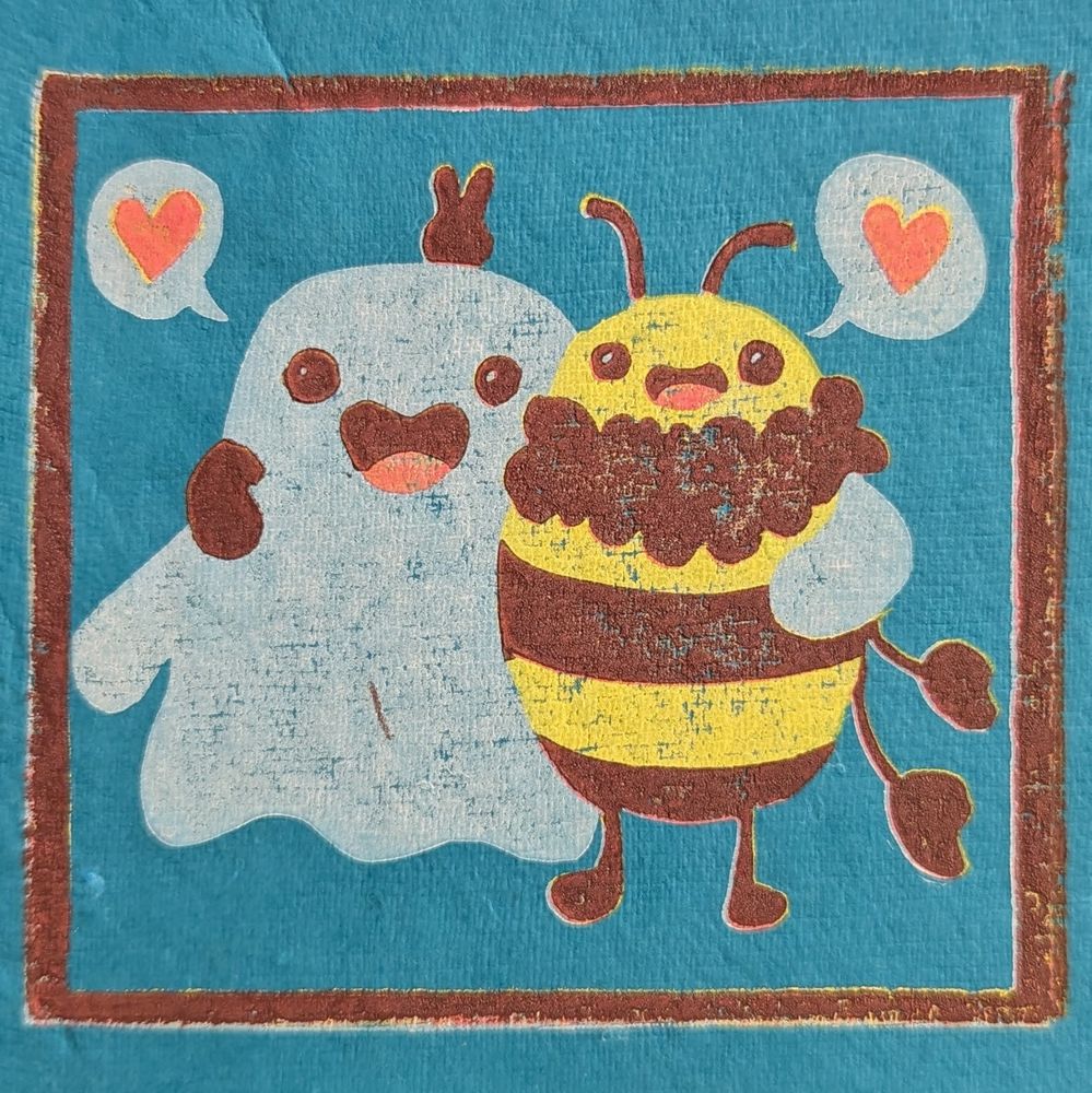 A rubber block reduction print featuring a white smiling cartoon ghost and a smiling yellow bee. The bee is holding a peace sign behind the ghosts head, and they both have speech bubbles with hearts.