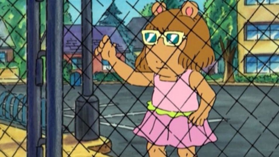 DW, from the PBS show ‘Arthur’, looking forlornly through a fence