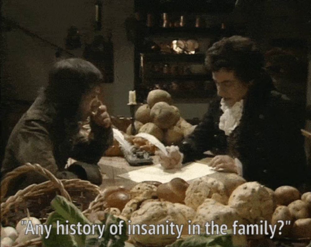 two men are sitting at a table with potatoes and bread and one of them says " any history of insanity in the family ? "