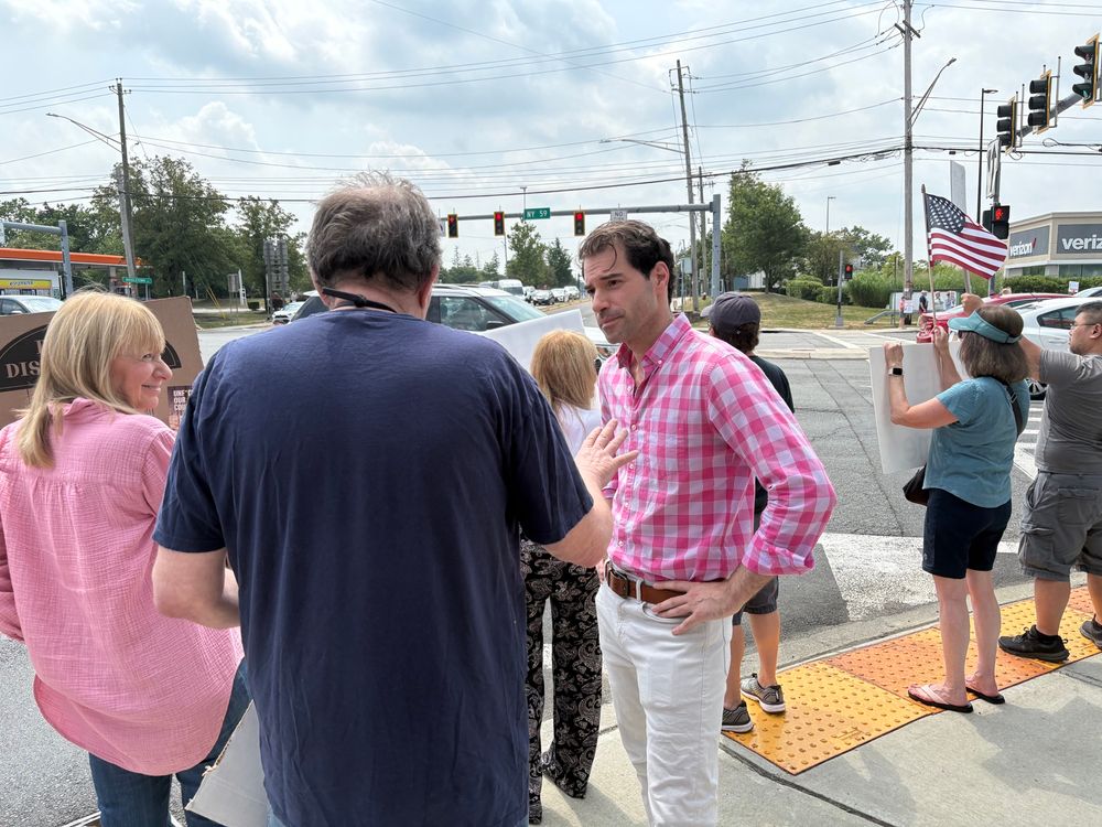 Mike Sacks on the street corner in Nanuet, NY, talking to some of the protesters who attend every Saturday. 