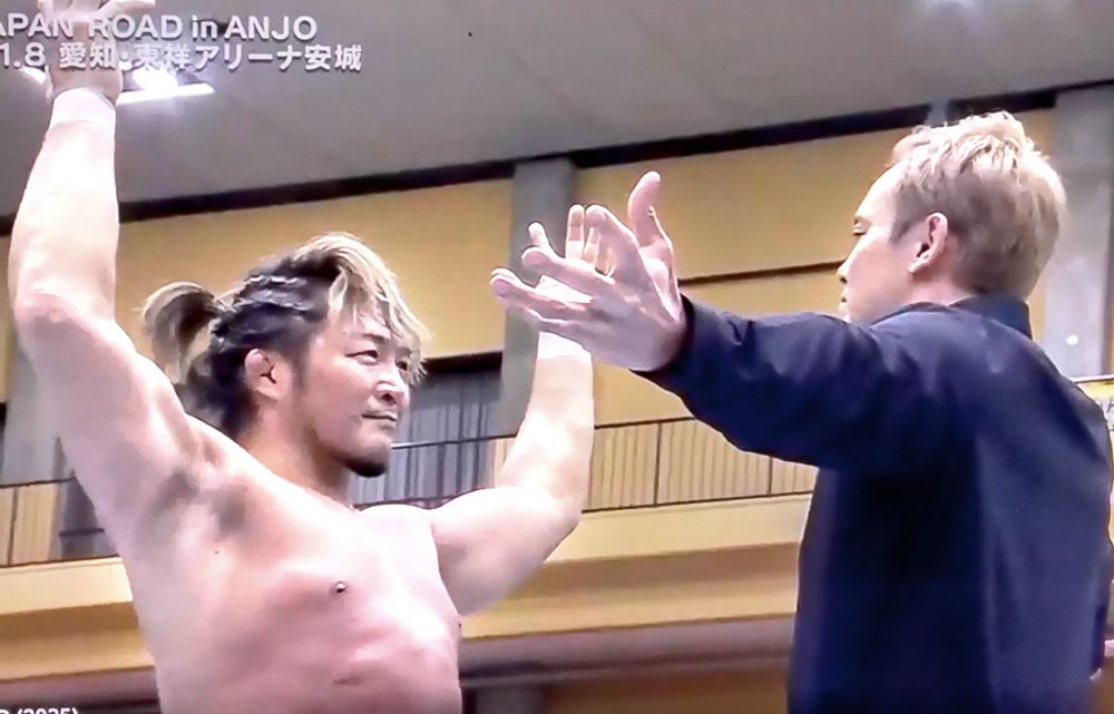 Japanese wrestlers Hiroshi Tanahashi and Kazuchika Okada face each other in the ring 