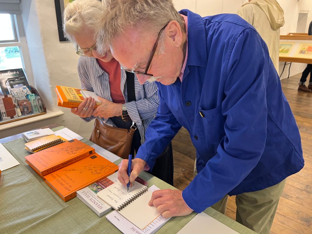 Glen Baxter signing books at Shandy Hall exhibition 